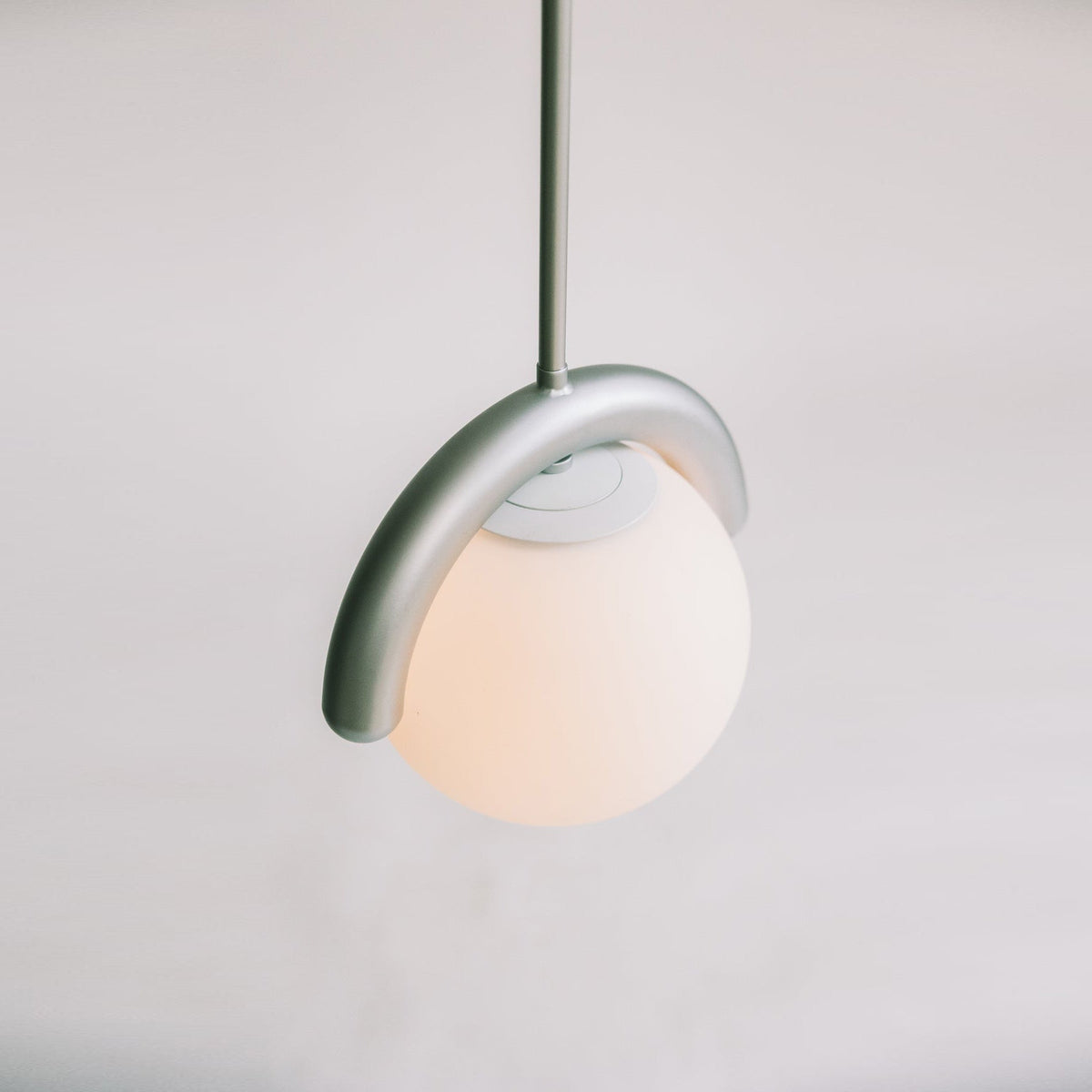 Modern Linear Chandelier with Curved Metal Frame & Glass Sphere – Art Nouveau Pendant Light for Dining Room | Thomler