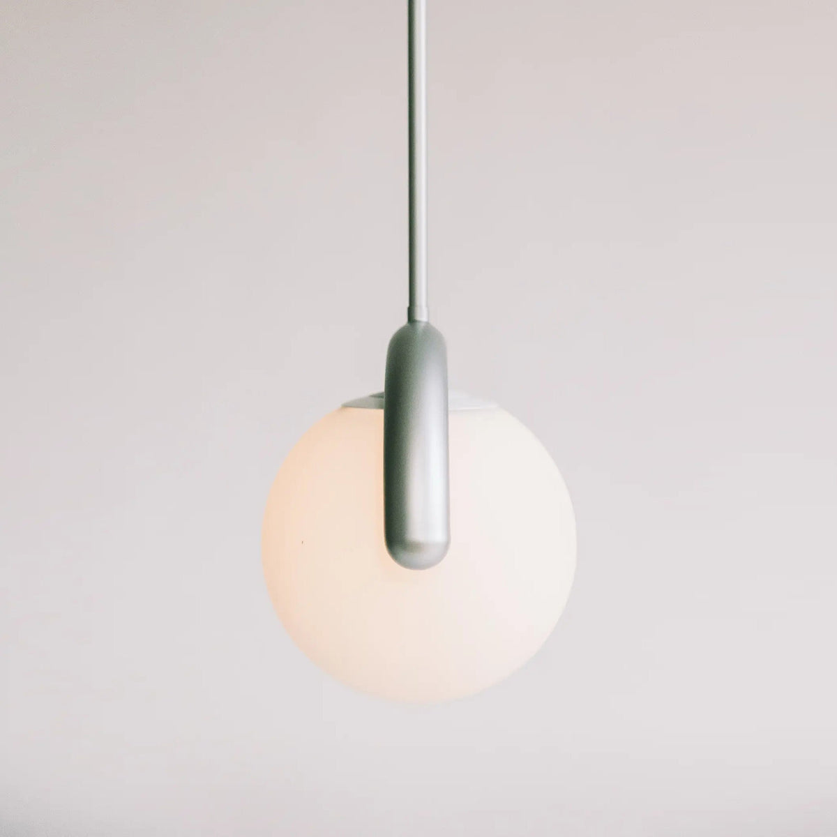 Modern Linear Chandelier with Curved Metal Frame & Glass Sphere – Art Nouveau Pendant Light for Dining Room | Thomler