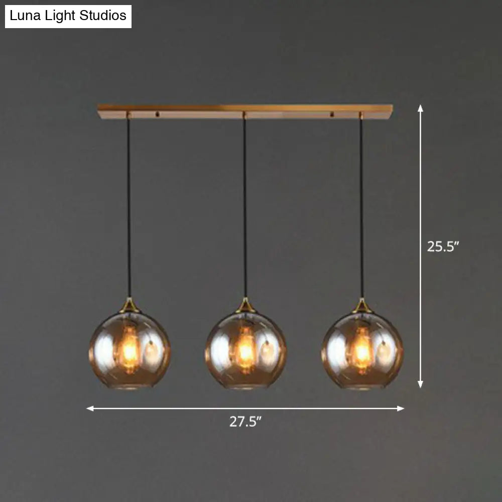 Three-Light Hanging Ceiling Fixture with Tapered Glass Globes in Antique Brass Finish for Dining Room Kitchen Island | Thomler